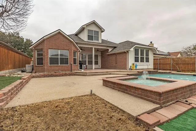 a front view of a house with yard and trees