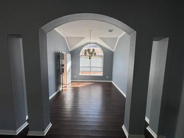 a view of an entryway with wooden floor