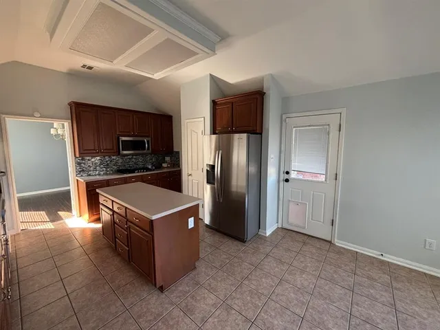 a kitchen with stainless steel appliances a refrigerator a stove a sink and dishwasher