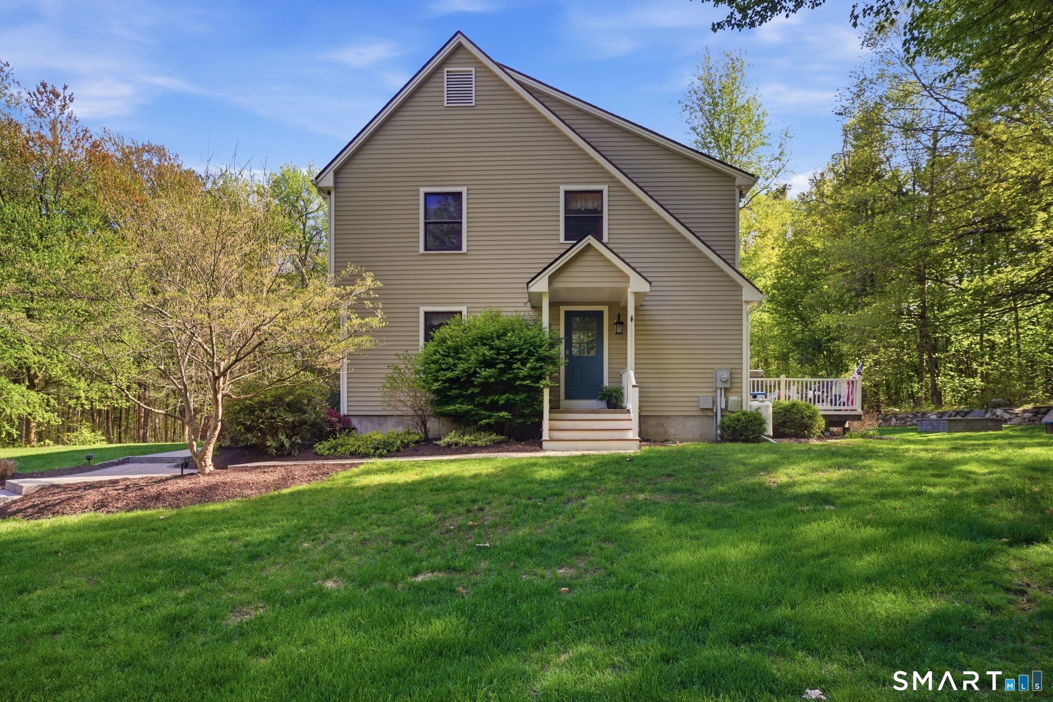 174 Walnut Hill Road Hartland, CT 06027 - Photo 3 of 36 a front view of a house with a yard and trees