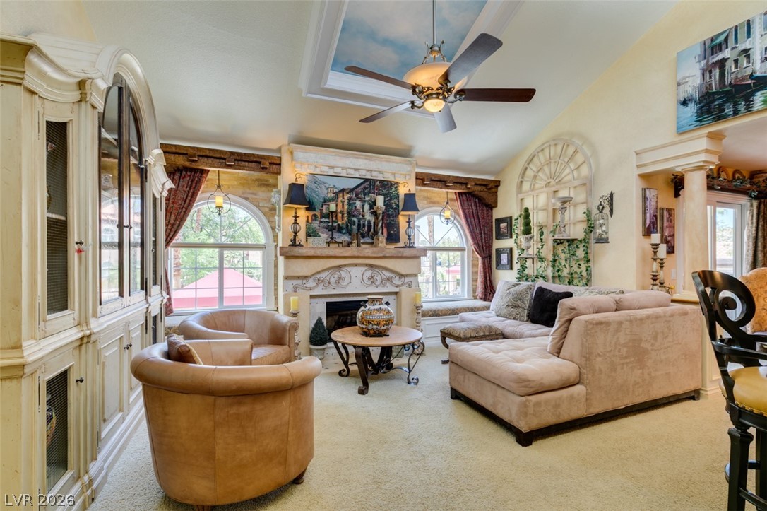 9325 West Desert Inn Road, Unit 244 Las Vegas, NV 89117 - Photo 5 of 55 The inviting living room offers high ceilings and a cozy fireplace, perfect for intimate gatherings.