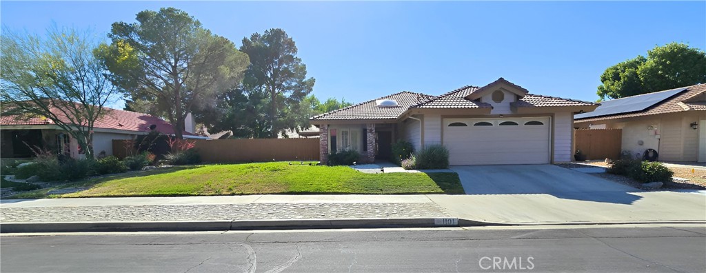 1101 North Heritage Drive Ridgecrest, CA 93555 - Photo 1 of 1 a front view of a house with a yard and garage