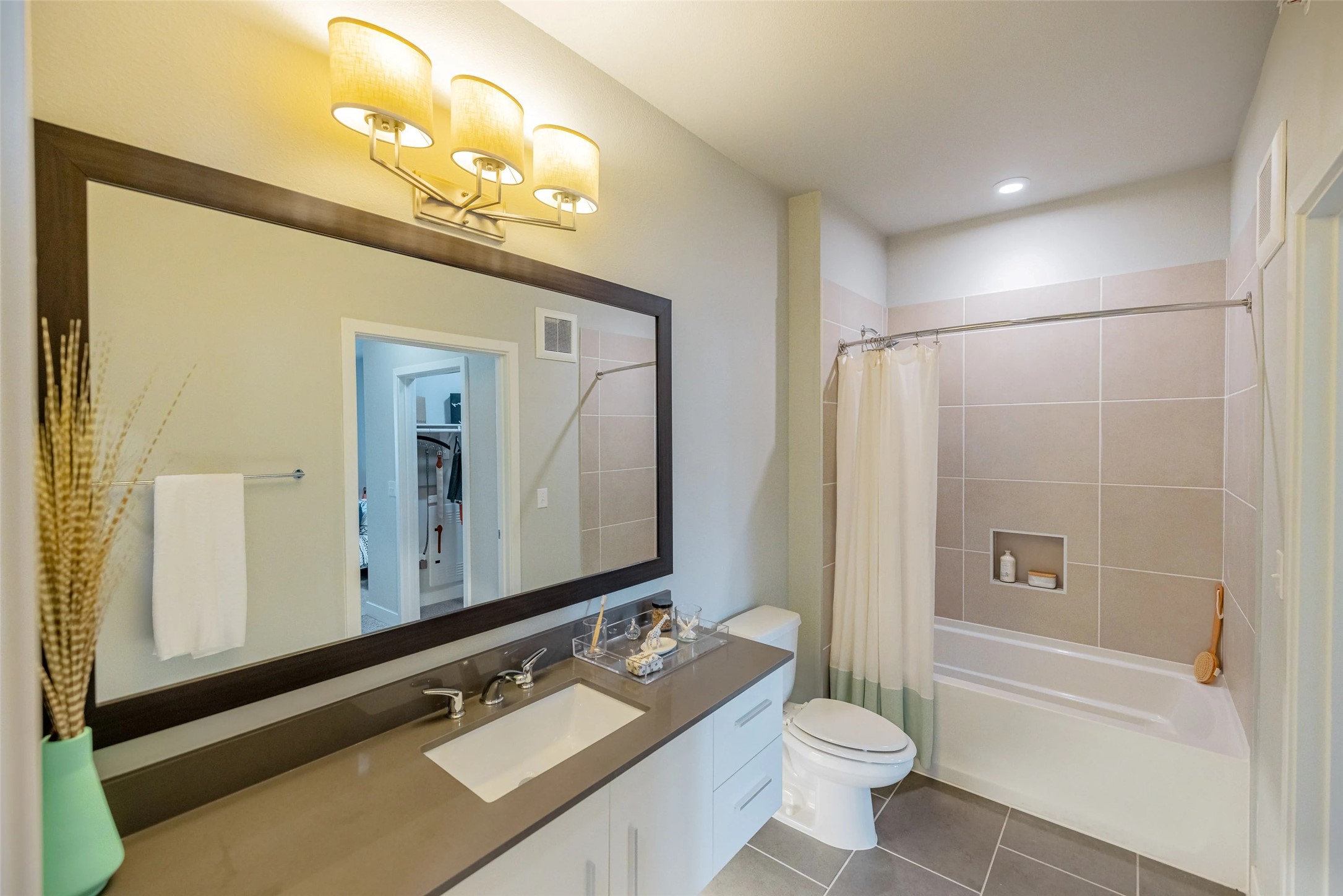 4800 Steiner Ranch Boulevard, Unit 20104 Austin, TX 78732 - Photo 18 of 19 a bathroom with a sink a toilet a mirror and shower