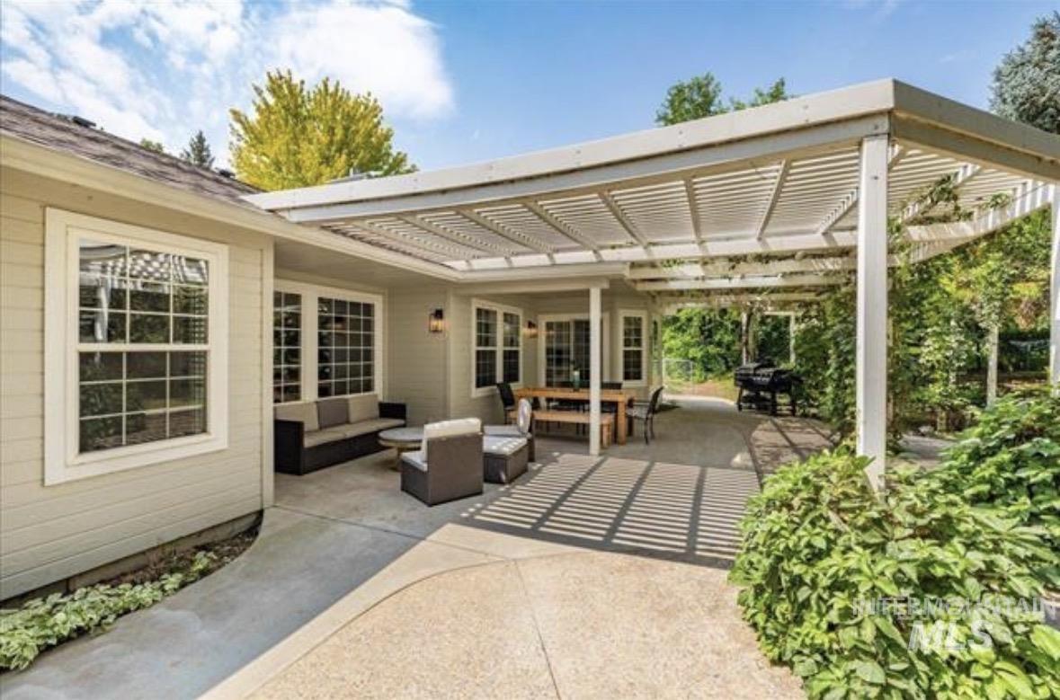 6600 East Victory Road Nampa, ID 83687 - Photo 14 of 19 Expansive concrete patio featuring a louvered pergola covering an outdoor dining area