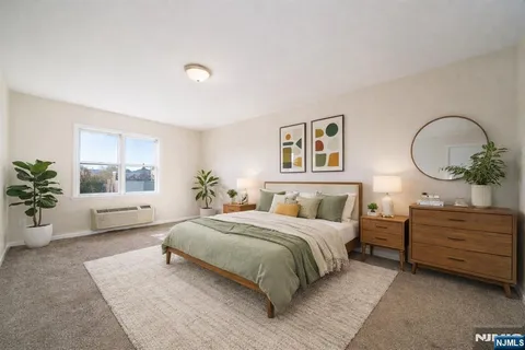 a bedroom with a large bed and a chandelier