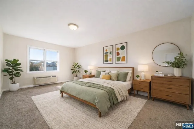 a bedroom with a large bed and a chandelier