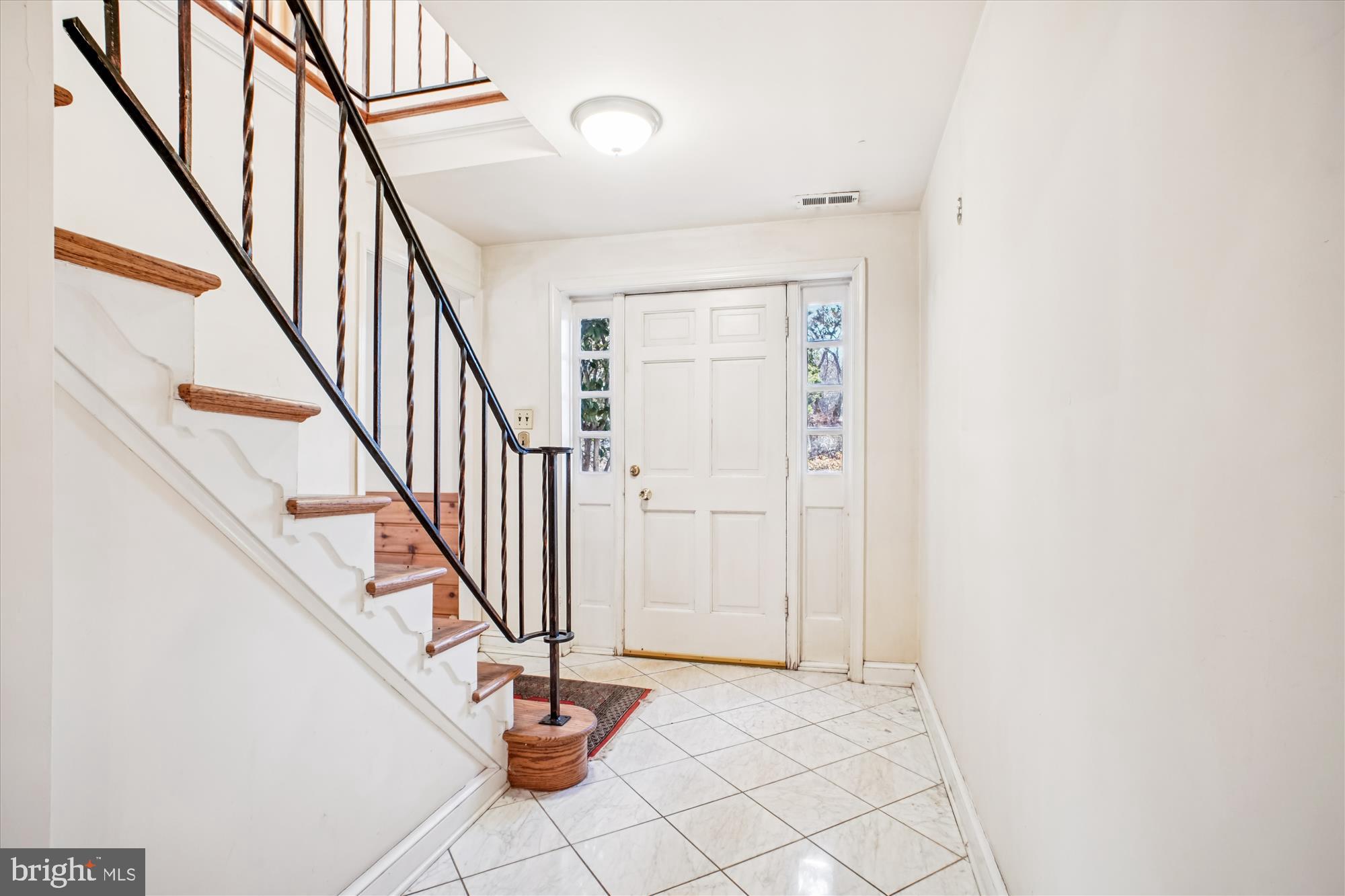 6144 Chesterbrook Road McLean, VA 22101 - Photo 14 of 50 a view of staircase with wooden floor and white walls