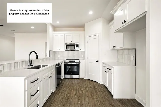a kitchen with stainless steel appliances sink a stove and a refrigerator