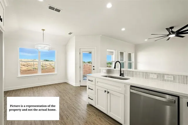a open kitchen with kitchen island a sink stainless steel appliances and cabinets