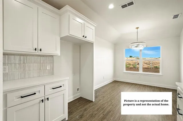 a view of kitchen with furniture and wooden floor
