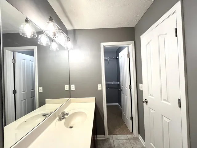a en suite bathroom with a sink a mirror and a shower