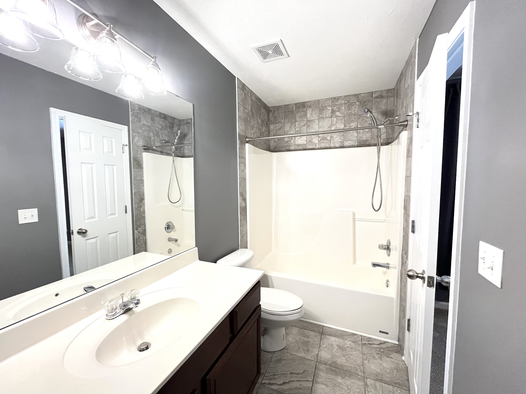 262 Arapaho Drive Murfreesboro, TN 37128 - Photo 20 of 24 a bathroom with a bathtub shower sink vanity and toilet