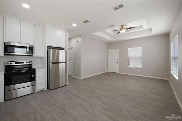 a kitchen with a refrigerator stove and microwave