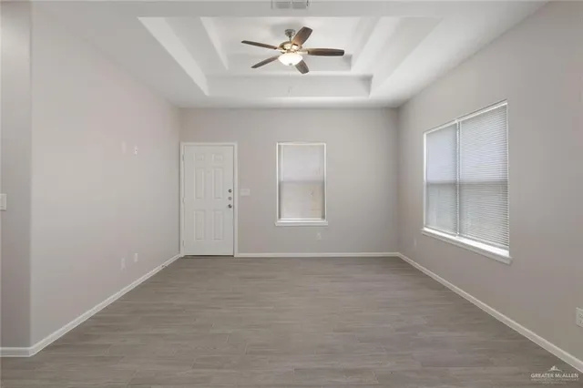 a view of an empty room with a kitchen