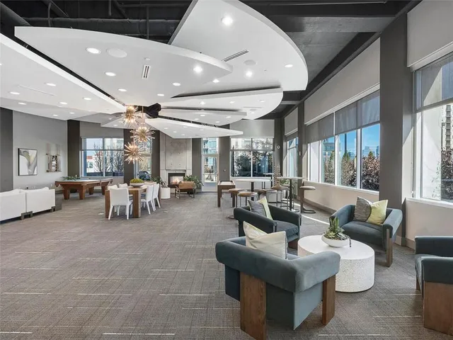 a lobby with furniture and large windows