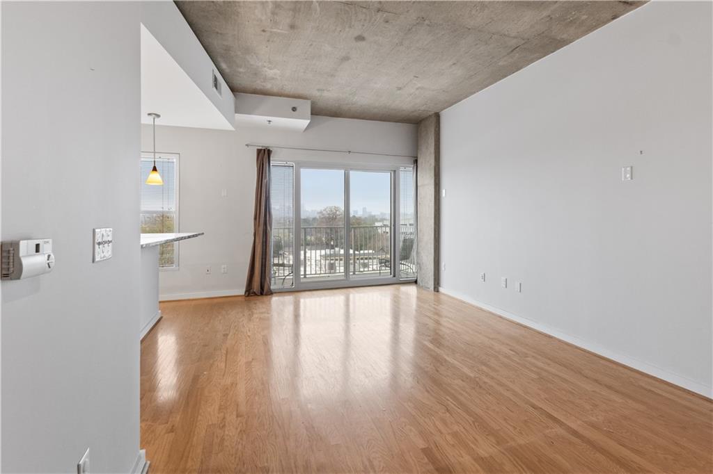 250 Pharr Road Northeast, Unit 514 Atlanta, GA 30305 - Photo 20 of 30 wooden floor in an empty room with a window