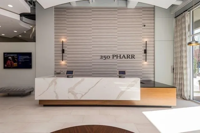 a white bath tub sitting next to a white wall