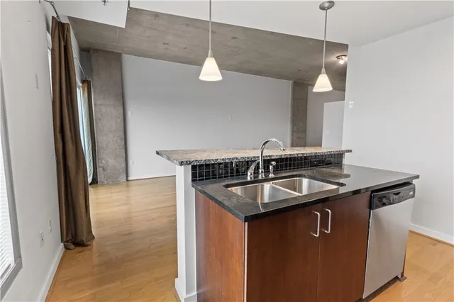 a bathroom with a granite countertop toilet a sink and a bathtub