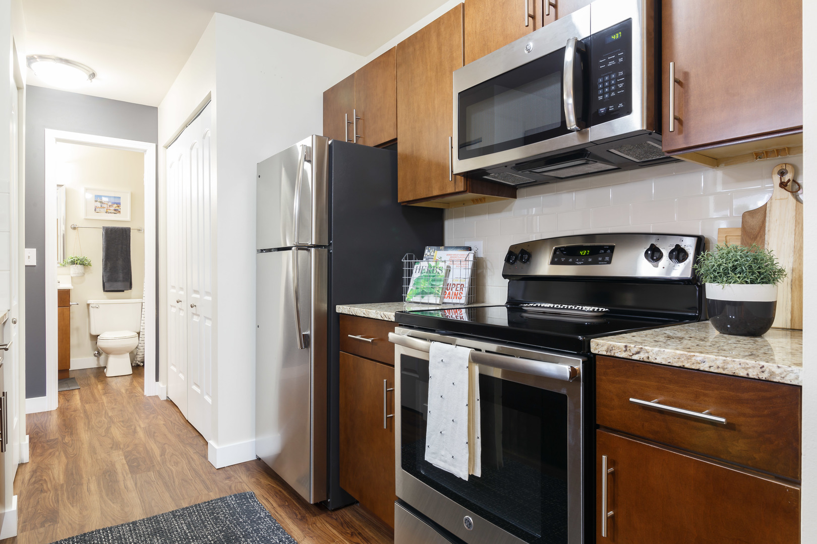 Undisclosed Address Wheaton, IL 60189 - Photo 5 of 17 a kitchen with stainless steel appliances granite countertop a stove microwave refrigerator and sink