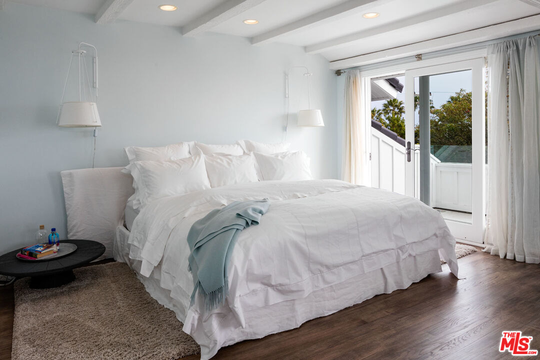 29225 Cliffside Drive Malibu, CA 90265 - Photo 19 of 33 a bedroom with a bed and wooden floor