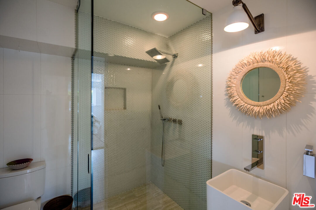 29225 Cliffside Drive Malibu, CA 90265 - Photo 27 of 33 a bathroom with a mirror a sink and a shower