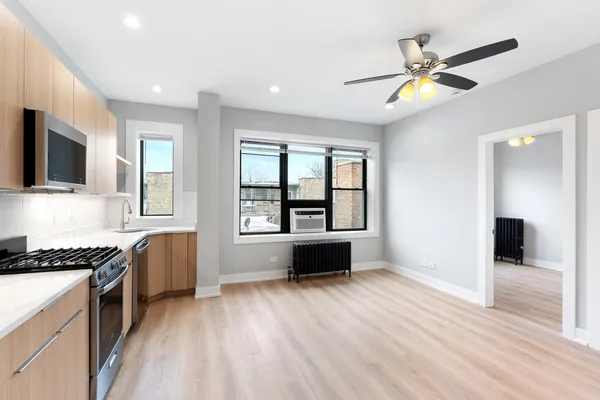 a kitchen with a refrigerator and a stove top oven