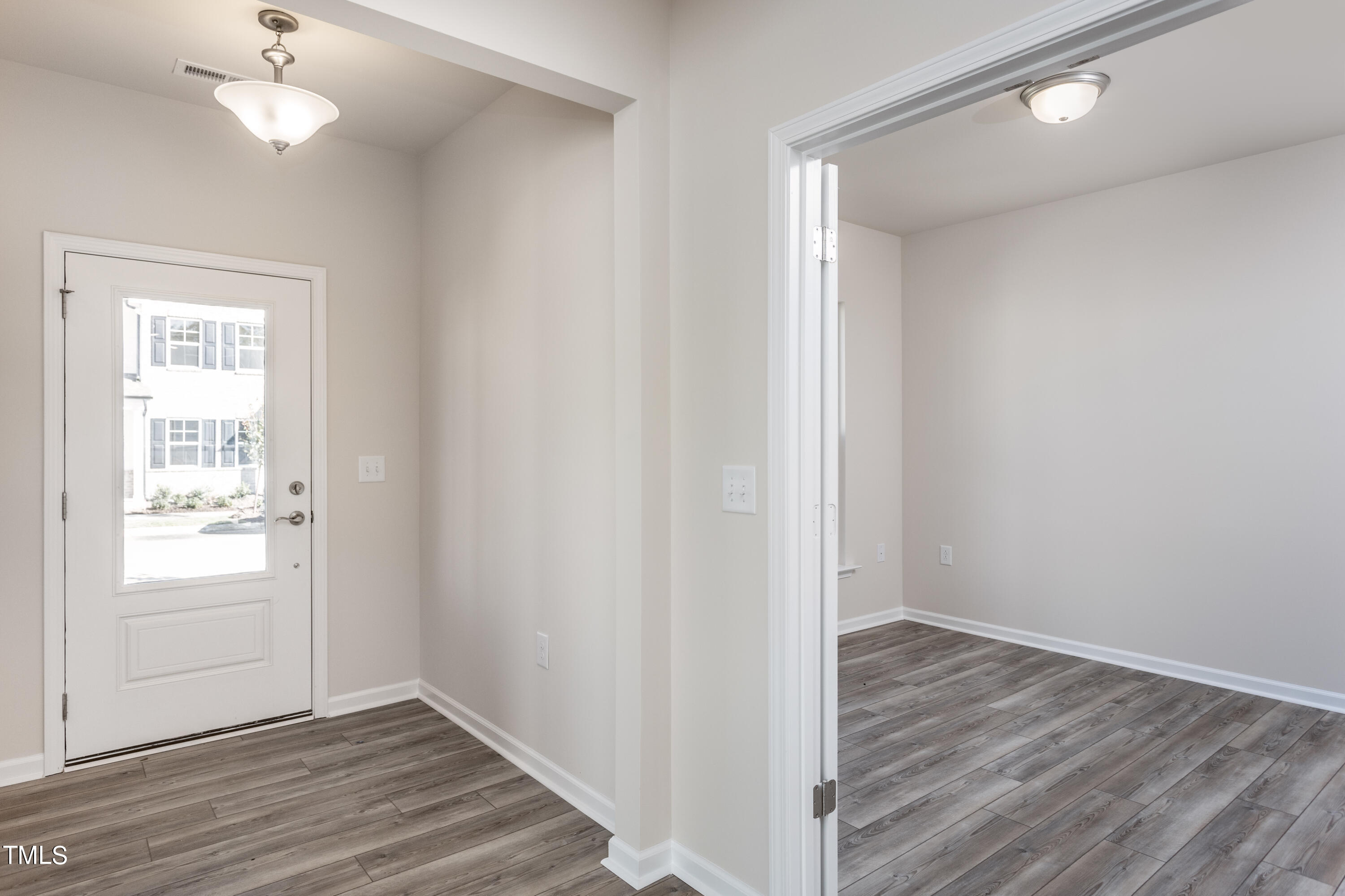 5008 Megara Raleigh, NC 27603 - Photo 3 of 21 wooden floor in an empty room with a window