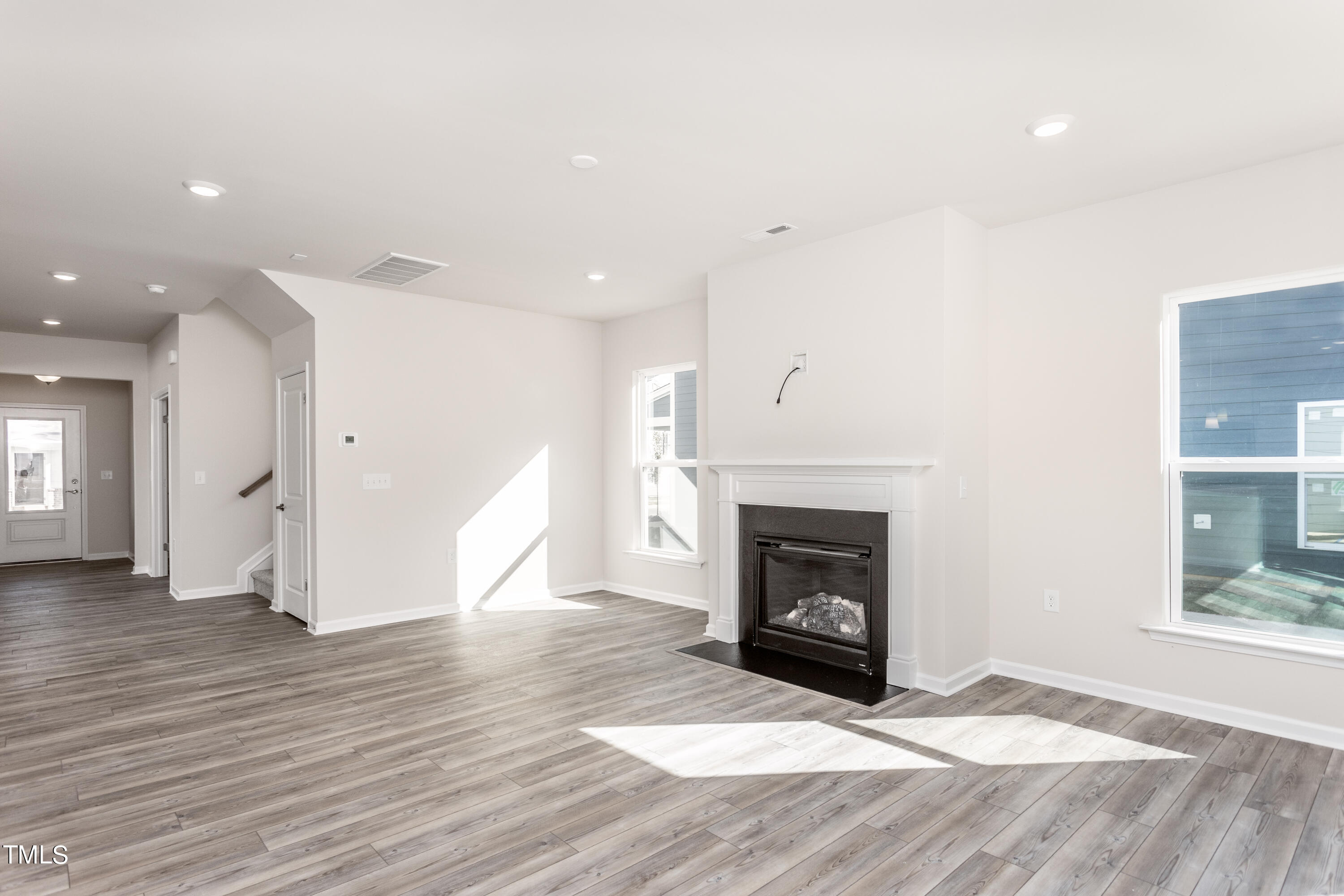 5008 Megara Raleigh, NC 27603 - Photo 8 of 21 a view of an empty room with wooden floor fireplace and a window