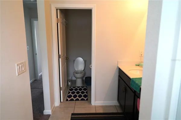 a view of a hallway with wooden floor and entryway