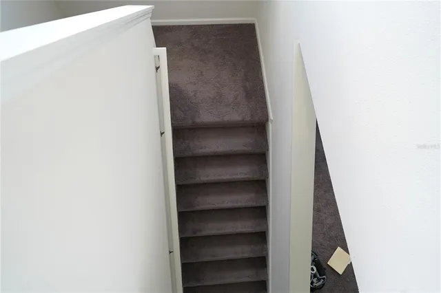 a view of staircase with white walls
