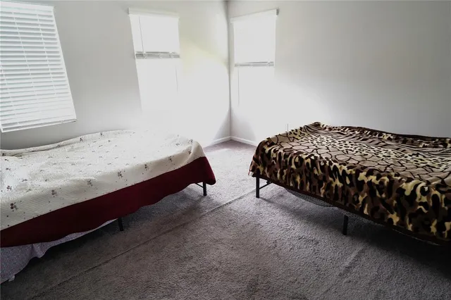 a bedroom with bed and window