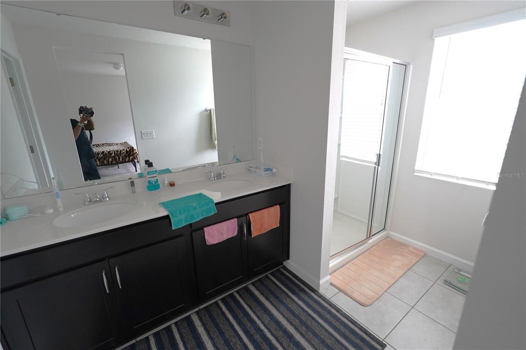 2850 Wadeview Loop St. Cloud, FL 34769 - Photo 9 of 17 a bathroom with a sink and a mirror