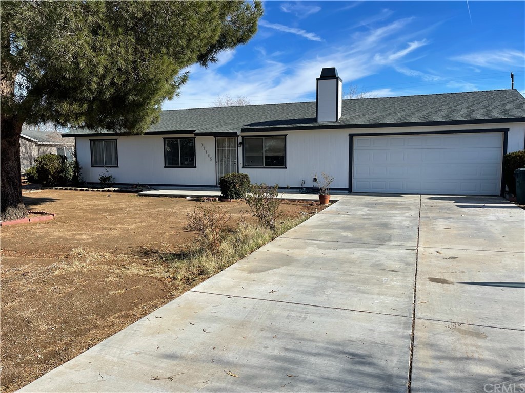 10805 Pinole Road Apple Valley, CA 92308 - Photo 1 of 1 a backyard of a house with table and chairs