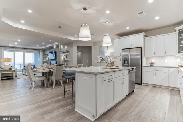a kitchen with stainless steel appliances kitchen island granite countertop a sink and cabinets