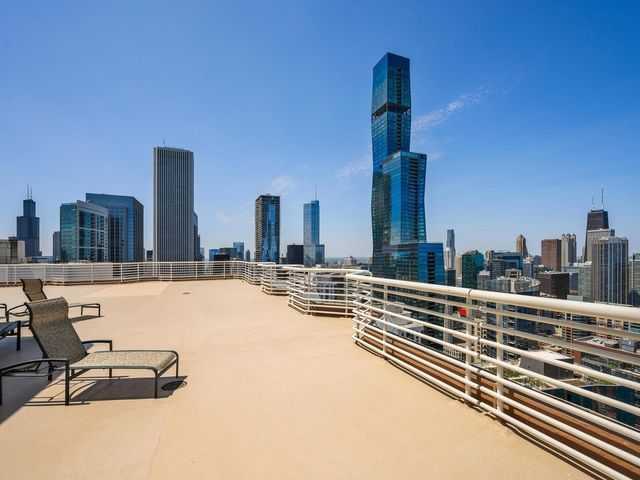 a view of swimming pool with outdoor seating and city view