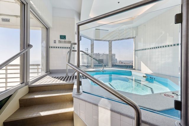 a view of swimming pool with furniture and window