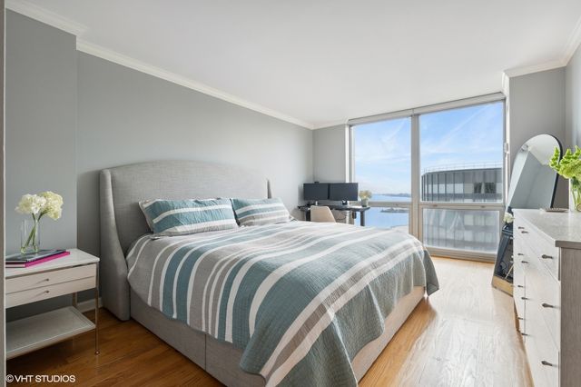 a bedroom with a bed and a view of living room