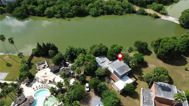 an aerial view of house with yard and lake view