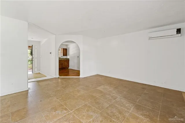 a view of an empty room with a fireplace and a window