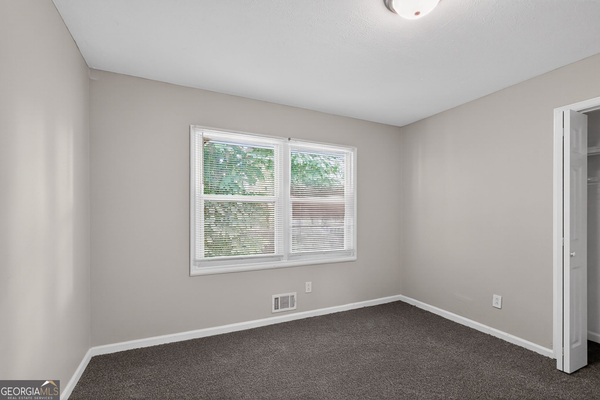 3285 Old Salem Road Southeast Conyers, GA 30013 - Photo 26 of 33 an empty room with a window