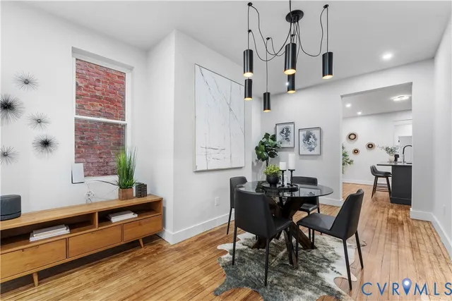 a view of a dining room with furniture window and wooden floor