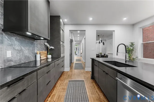 a kitchen with sink stove and refrigerator