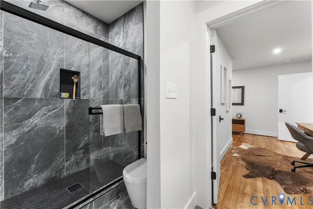 a bathroom with a granite countertop toilet sink and shower