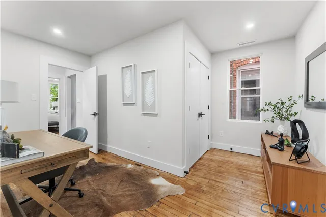 a view of a workspace with furniture and a potted plant
