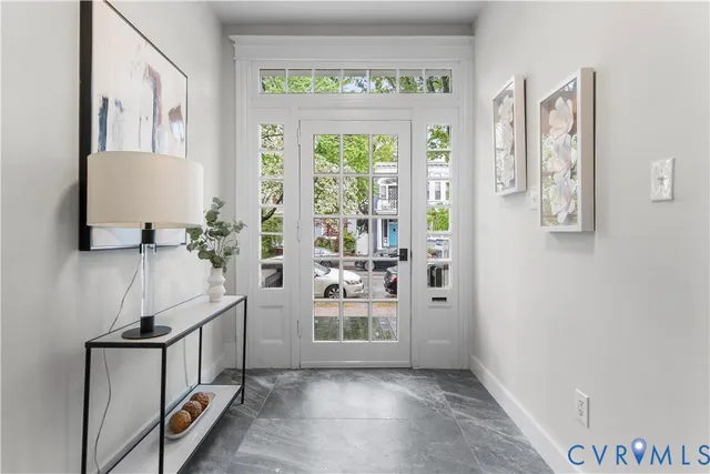 a view of an entryway with wooden floor