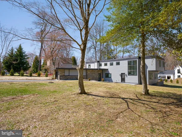 a view of a house with a yard and trees
