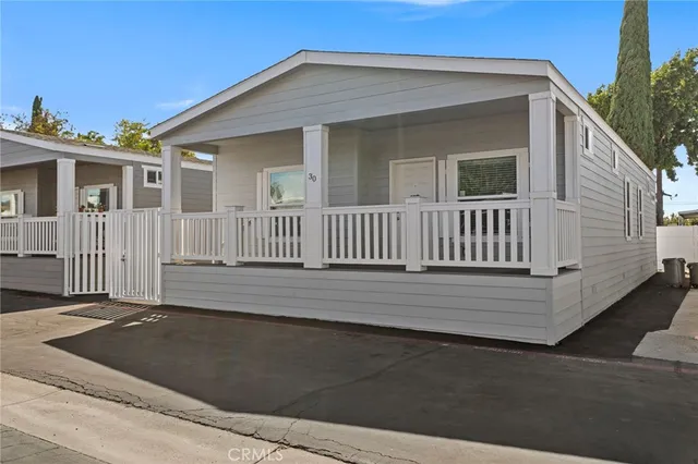 a view of a house with a wooden deck