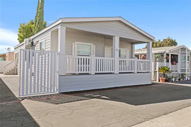a view of a house with a wooden fence