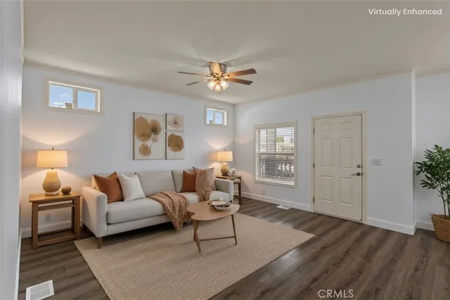 a living room with furniture and wooden floor