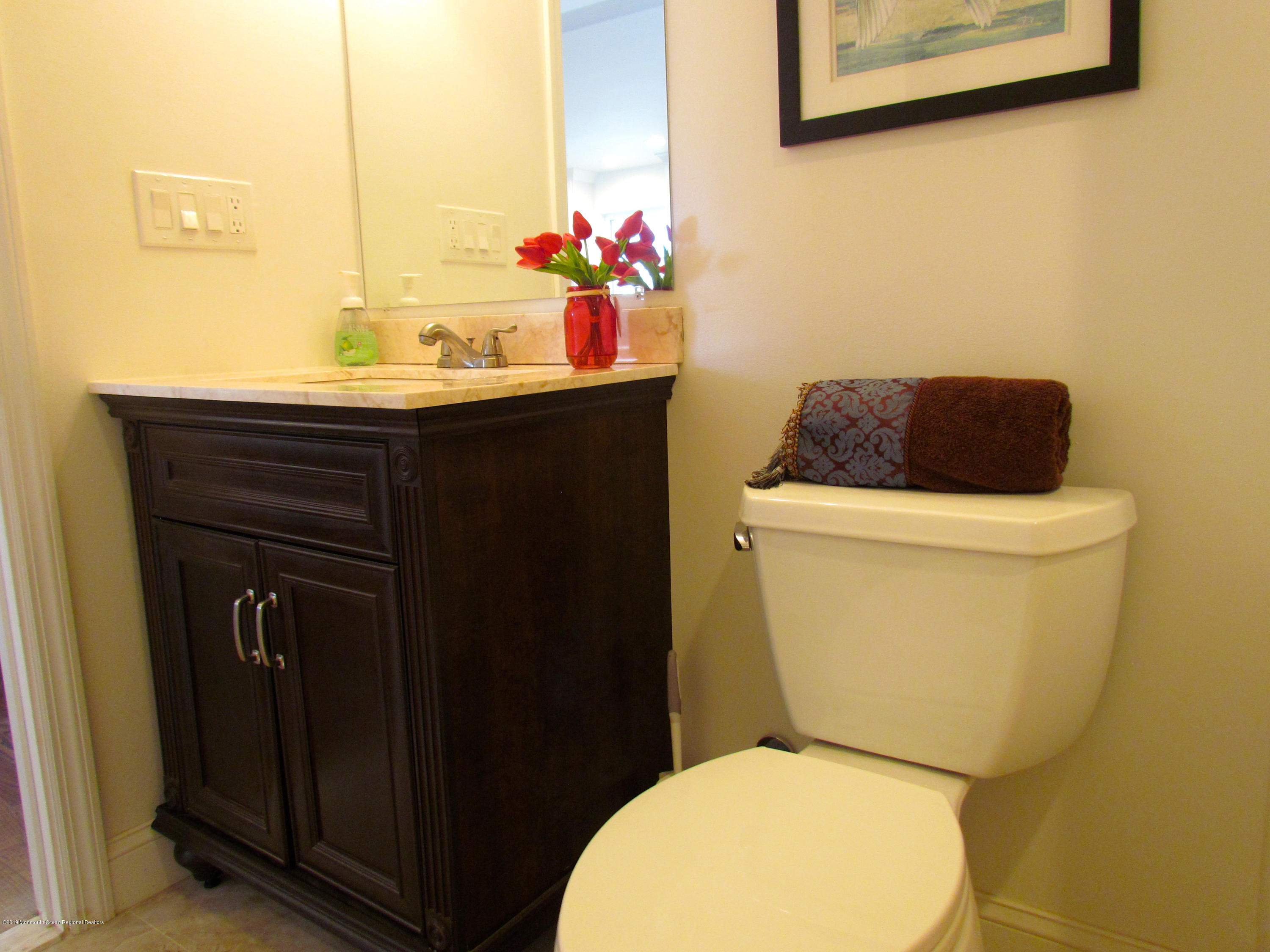 706 Drum Point Road Brick, NJ 08723 - Photo 30 of 39 a bathroom with a sink and a toilet